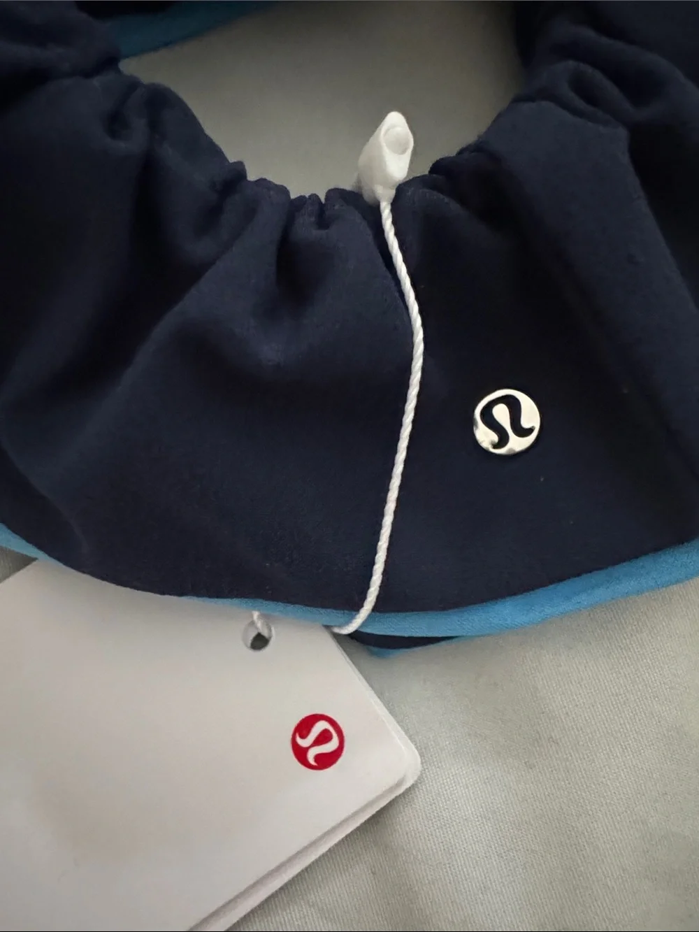lululemon navy scrunchie with sky blue trim